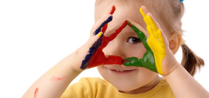 Kids doing a craft project with scissors and paper